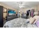 This well-lit bedroom features a ceiling fan, closet, and an entertainment center at 1063 S Hiawassee Rd # 1615, Orlando, FL 32835