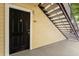 Condo entrance door with staircase leading to upper levels, providing convenient access at 1063 S Hiawassee Rd # 1615, Orlando, FL 32835
