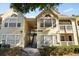 Charming yellow two-story condo building with well-maintained landscaping and inviting entryway at 1063 S Hiawassee Rd # 1615, Orlando, FL 32835