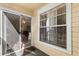 A cozy screened patio with natural light coming through the sliding glass door at 1063 S Hiawassee Rd # 1615, Orlando, FL 32835