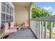Covered balcony features three plastic chairs and wood railings at 1065 S Hiawassee Rd # 1436, Orlando, FL 32835
