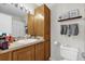 Bathroom featuring tile flooring, wood cabinets, and a shower/tub at 1065 S Hiawassee Rd # 1436, Orlando, FL 32835