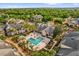 Aerial view of a community pool with palm trees, lounge chairs, and lush landscaping at 1065 S Hiawassee Rd # 1436, Orlando, FL 32835