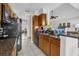 Bright kitchen with granite countertops, wood cabinets, and modern appliances at 1065 S Hiawassee Rd # 1436, Orlando, FL 32835