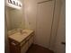 Bathroom features a vanity with a mirror and cabinet space, and a white closet door at 1075 S Hiawassee Rd # 916, Orlando, FL 32835