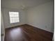 Cozy bedroom with laminate flooring, a ceiling fan, and a bright window at 1075 S Hiawassee Rd # 916, Orlando, FL 32835