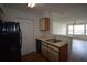 Functional kitchen with laminate flooring, including view to the living room at 1075 S Hiawassee Rd # 916, Orlando, FL 32835