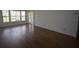 Bright living room with laminate flooring and ample natural light from large windows at 1075 S Hiawassee Rd # 916, Orlando, FL 32835