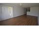 Inviting living room featuring laminate flooring and a ceiling fan, with a partial view of the kitchen at 1075 S Hiawassee Rd # 916, Orlando, FL 32835