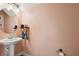 Elegant half-bathroom with a pedestal sink and stylish fixtures at 1350 Royal St George Blvd, Davenport, FL 33896