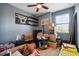 Bedroom filled with boxes, shelves, and a boombox print on the wall, reflecting a lived-in space at 1350 Royal St George Blvd, Davenport, FL 33896