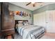 Bedroom featuring a bed, carpet, ceiling fan, closet, gray walls, and decorated with anime-themed artwork at 1350 Royal St George Blvd, Davenport, FL 33896