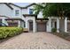 Inviting two-story townhome featuring a paver driveway and attached one-car garage at 1350 Royal St George Blvd, Davenport, FL 33896