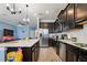 Open-concept kitchen with stainless steel appliances, dark cabinetry, and a bright, airy feel at 1350 Royal St George Blvd, Davenport, FL 33896