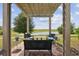 Inviting patio with pergola, outdoor seating, string lights, and serene lake view at 1350 Royal St George Blvd, Davenport, FL 33896
