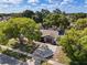 Aerial image of a home with a private driveway, lush green trees, and a well-kept landscape at 1360 Springfield St, Kissimmee, FL 34744