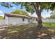 This property boasts a generous backyard with mature trees that offer ample shade and tranquility at 1360 Springfield St, Kissimmee, FL 34744