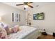 Comfortable bedroom with closet and cozy bed next to a tv screen on the wall at 1360 Springfield St, Kissimmee, FL 34744