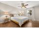 Cozy bedroom with a queen bed, ceiling fan, neutral walls, and window with sheer curtains at 1360 Springfield St, Kissimmee, FL 34744