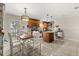 Bright, open dining area features wood table, white chairs, and stylish pendant lighting near the modern kitchen at 1360 Springfield St, Kissimmee, FL 34744