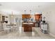 Open kitchen and dining area featuring dark wood cabinets, a kitchen island, stainless steel appliances, and tile flooring at 1360 Springfield St, Kissimmee, FL 34744