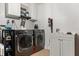 Well-equipped laundry room boasts modern washer, dryer, utility sink, and ample storage space at 1360 Springfield St, Kissimmee, FL 34744