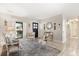 Inviting living room featuring neutral tones, stylish seating arrangements, decorative mirrors and tile flooring at 1360 Springfield St, Kissimmee, FL 34744