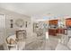 Open living space with tile floors seamlessly connects the living room, dining area, and kitchen, perfect for entertaining at 1360 Springfield St, Kissimmee, FL 34744