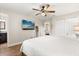 Spacious main bedroom includes a serene atmosphere, ceiling fan, tv, and ensuite bathroom at 1360 Springfield St, Kissimmee, FL 34744