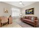 Comfortable office with a pink couch and desk next to a window with curtains at 1360 Springfield St, Kissimmee, FL 34744