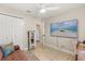 Cozy office with modern furniture next to an office closet and TV screen on the wall at 1360 Springfield St, Kissimmee, FL 34744