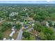 Overhead view of a home surrounded by lush trees, accessible roads, and neighborhood charm at 1440 Lake Shore Dr, Casselberry, FL 32707