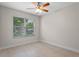 Bedroom with wood-look tile floors, ceiling fan with light and bright window to allow natural light at 1440 Lake Shore Dr, Casselberry, FL 32707