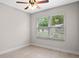 Comfortable bedroom with wood-look floors, a ceiling fan and window to allow in natural light at 1440 Lake Shore Dr, Casselberry, FL 32707