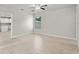 Bright bedroom features wood-look tile flooring, ceiling fan, and a window bringing in natural light at 1440 Lake Shore Dr, Casselberry, FL 32707