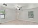 Light-filled bedroom with white walls, neutral flooring, ceiling fan and large, bright windows at 1440 Lake Shore Dr, Casselberry, FL 32707