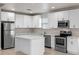 Updated kitchen with stainless steel appliances, an island, and modern white cabinetry at 1440 Lake Shore Dr, Casselberry, FL 32707