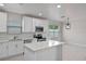 Kitchen features new stainless appliances, white cabinets, island, and plentiful natural light at 1440 Lake Shore Dr, Casselberry, FL 32707
