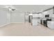Open floor plan with white walls, tile flooring, and updated stainless steel kitchen appliances at 1440 Lake Shore Dr, Casselberry, FL 32707