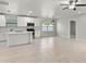 Bright open floor plan with white cabinets, stainless appliances, an island, and new floors at 1440 Lake Shore Dr, Casselberry, FL 32707