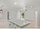 Bright and airy living room with neutral paint, light wood floors, ceiling fan, and a large island at 1440 Lake Shore Dr, Casselberry, FL 32707