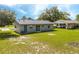 The backyard view showcases a single-story home with a grassy lawn at 14796 Sw 39Th Cir, Ocala, FL 34473