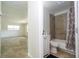 View into bathroom, highlighting the neutral tile surround of bathtub and white vanity at 14796 Sw 39Th Cir, Ocala, FL 34473