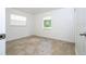 Bright bedroom with tile flooring, two windows, and neutral walls offers a serene space at 14796 Sw 39Th Cir, Ocala, FL 34473