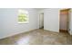 Bedroom featuring tile flooring, natural light from a window, and a doorway to another room at 14796 Sw 39Th Cir, Ocala, FL 34473