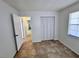 Bright bedroom with tile floors, a closet with bi-fold doors and a window at 14796 Sw 39Th Cir, Ocala, FL 34473