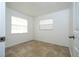 Clean and minimalist bedroom featuring tile flooring and two windows for ample natural light at 14796 Sw 39Th Cir, Ocala, FL 34473