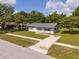 An angled front view of a well-kept home with a driveway and green lawn at 14796 Sw 39Th Cir, Ocala, FL 34473
