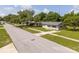 A wide street view shows a single-story home with green lawns and sidewalks at 14796 Sw 39Th Cir, Ocala, FL 34473