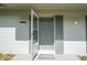 Welcoming front entrance with an open screen door, showcasing the home's exterior features and curb appeal at 14796 Sw 39Th Cir, Ocala, FL 34473